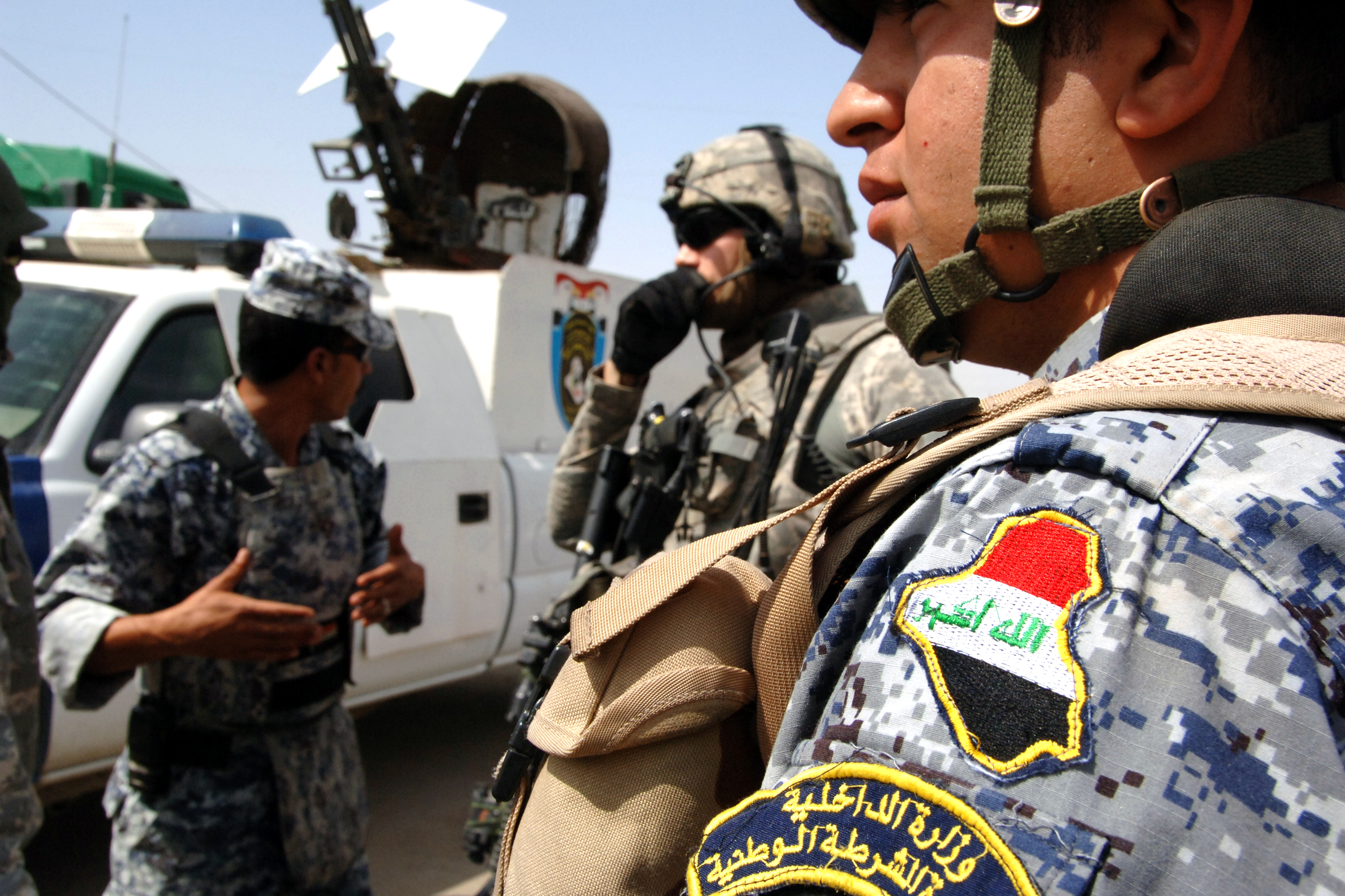 U.S. Army Staff Sgt. David Snow, from Military Police Platoon, Headquarters and Headquarters Company, Brigade Special Troops Battalion, 4th Brigade Combat Team, 10th Mountain Division out of Fort Polk, La., speaks to an Iraqi National Police shift leader at a traffic checkpoint near Forward Operating Base Loyalty in Southern Baghdad, May 11, 2008, while his unit conducts a spot check patrol of checkpoints around their base to assess their needs and collect information on sightings of suspicious activity.  (U.S. Army photo by Staff Sgt. Brian D. Lehnhardt/Released)